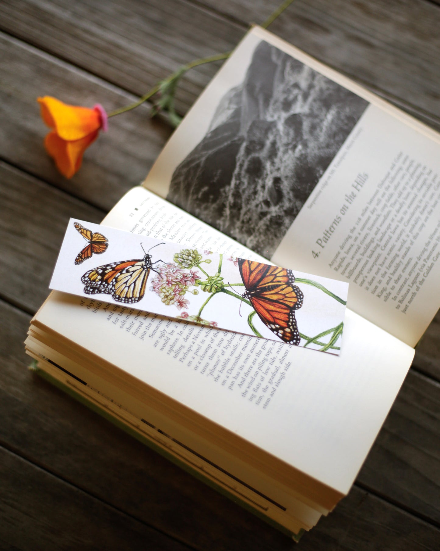 Bookmark with monarch butterflies surrounding a milkweed plant.