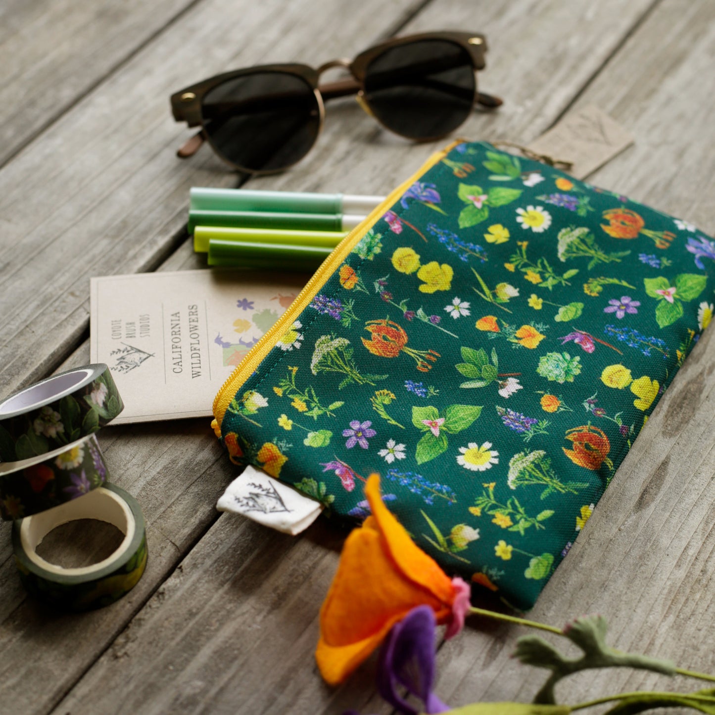 Wildflower pouch with washi tape and sunglasses next to it.