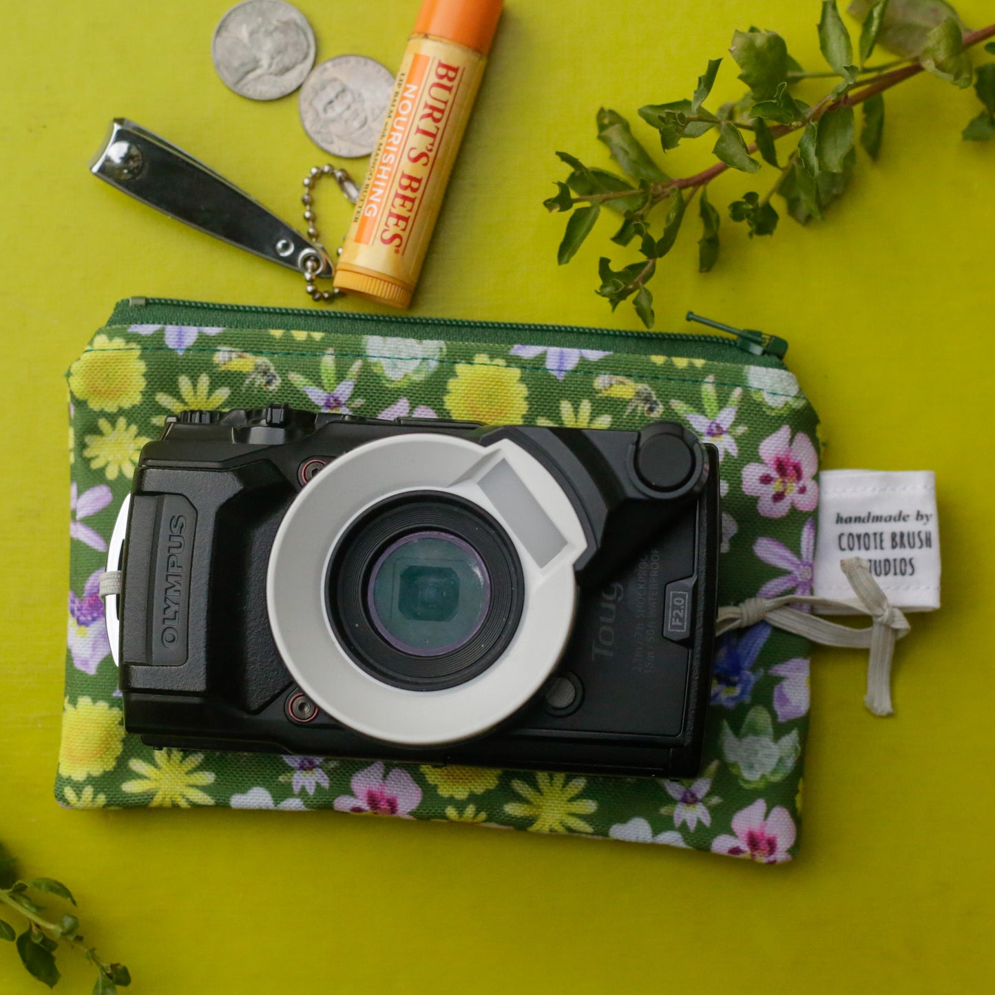 A small camera is on top of the pouch to show it could fit inside. 