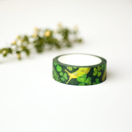 Load image 1 in gallery view. Dark green roll of tape printed with sorrel, ferns, and banana slugs. 
